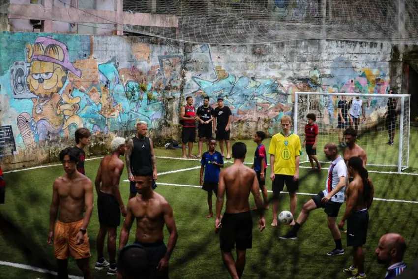 Street football game on a community pitch in Rocinha